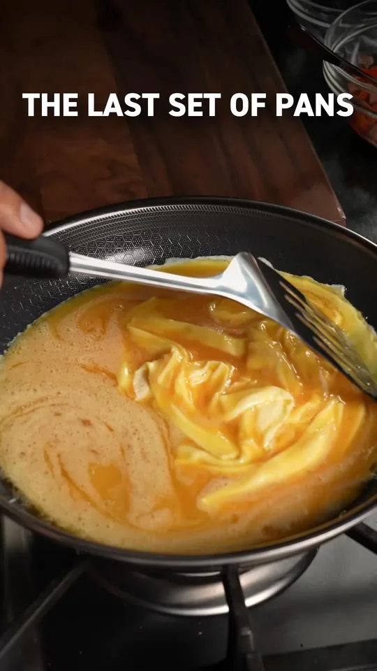 HexClad's video ad, still frame: eggs being scrambled in the pan under the headline The last set of pans.